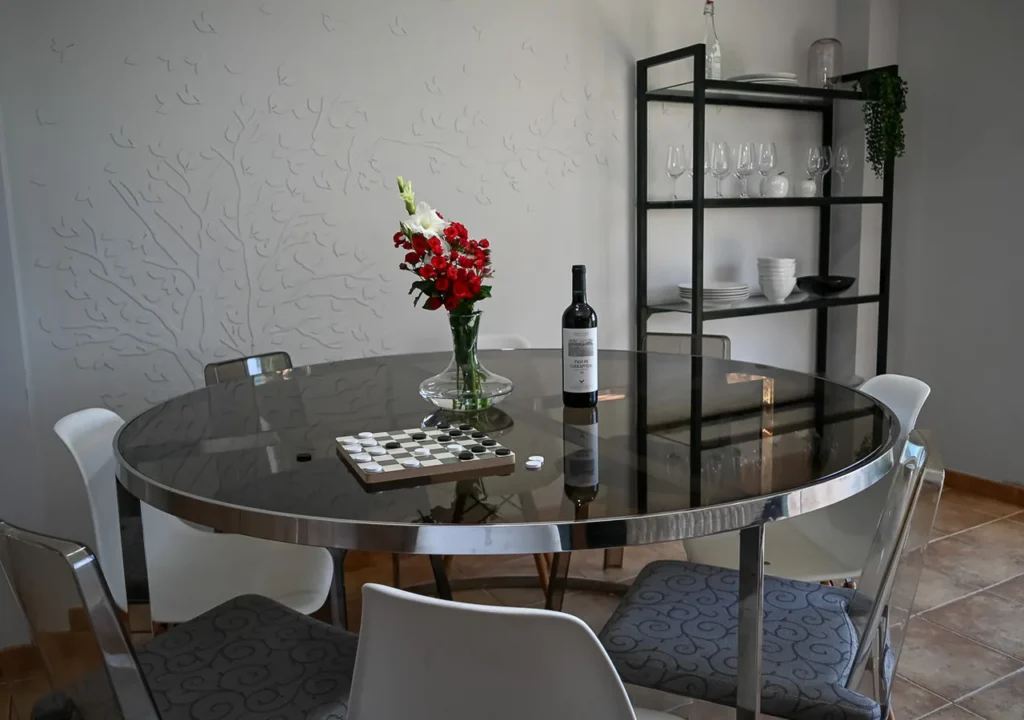 Comedor interior con mesa redonda y estantería en O Igrexario Vacacional