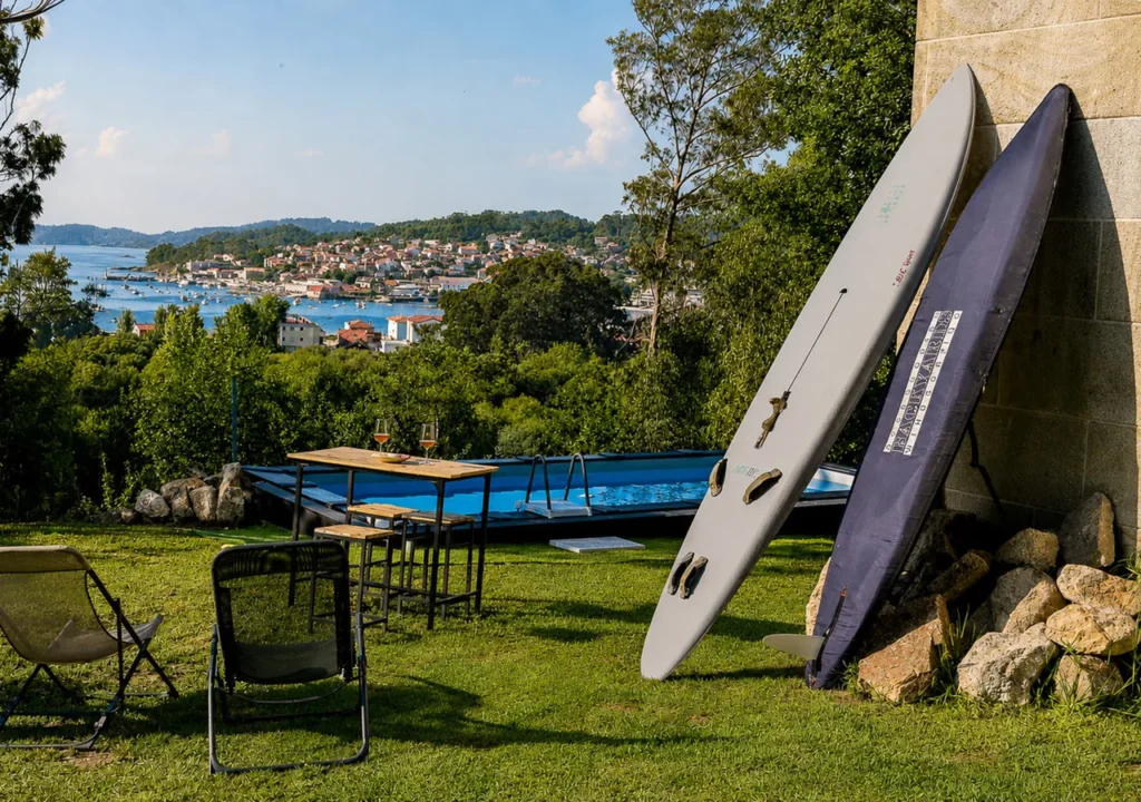 Jardín con piscina, tablas de windsurf y vistas a la ría de Aldán en O Igrexario Vacacional