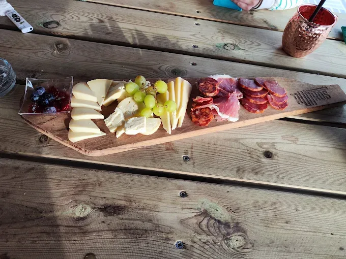 Tabla de quesos, embutidos, uvas y confitura servida en Kunkos Restaurante